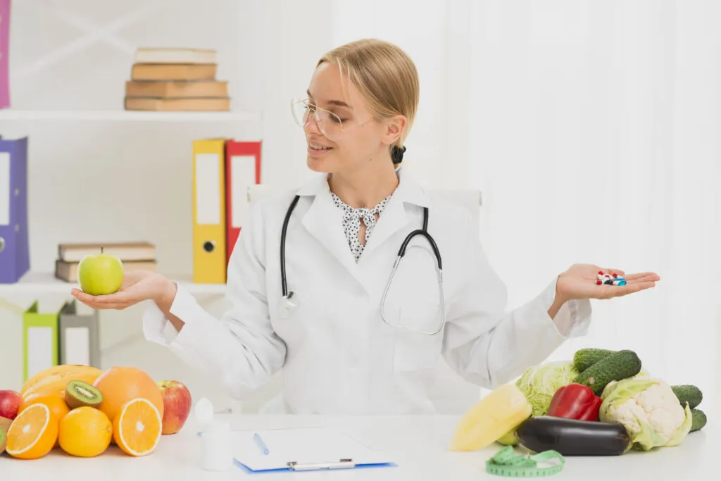 Medium Shot Doctor Holding Up Apple Pills